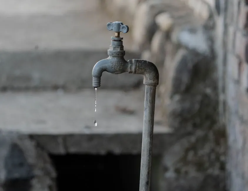 Leaking outdoor faucet dripping water