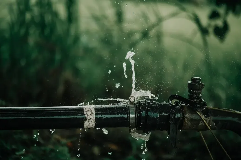 Water spraying from a leaking outdoor water line