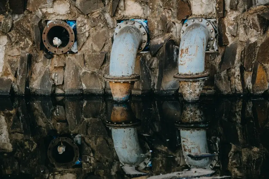 Old corroded drain pipes with standing water