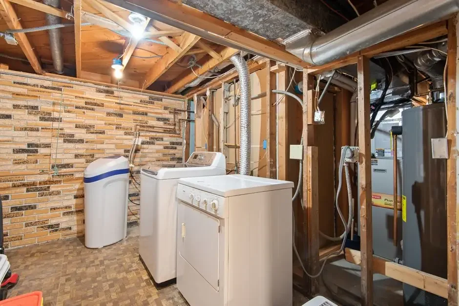 Laundry room with a water heater and water softener